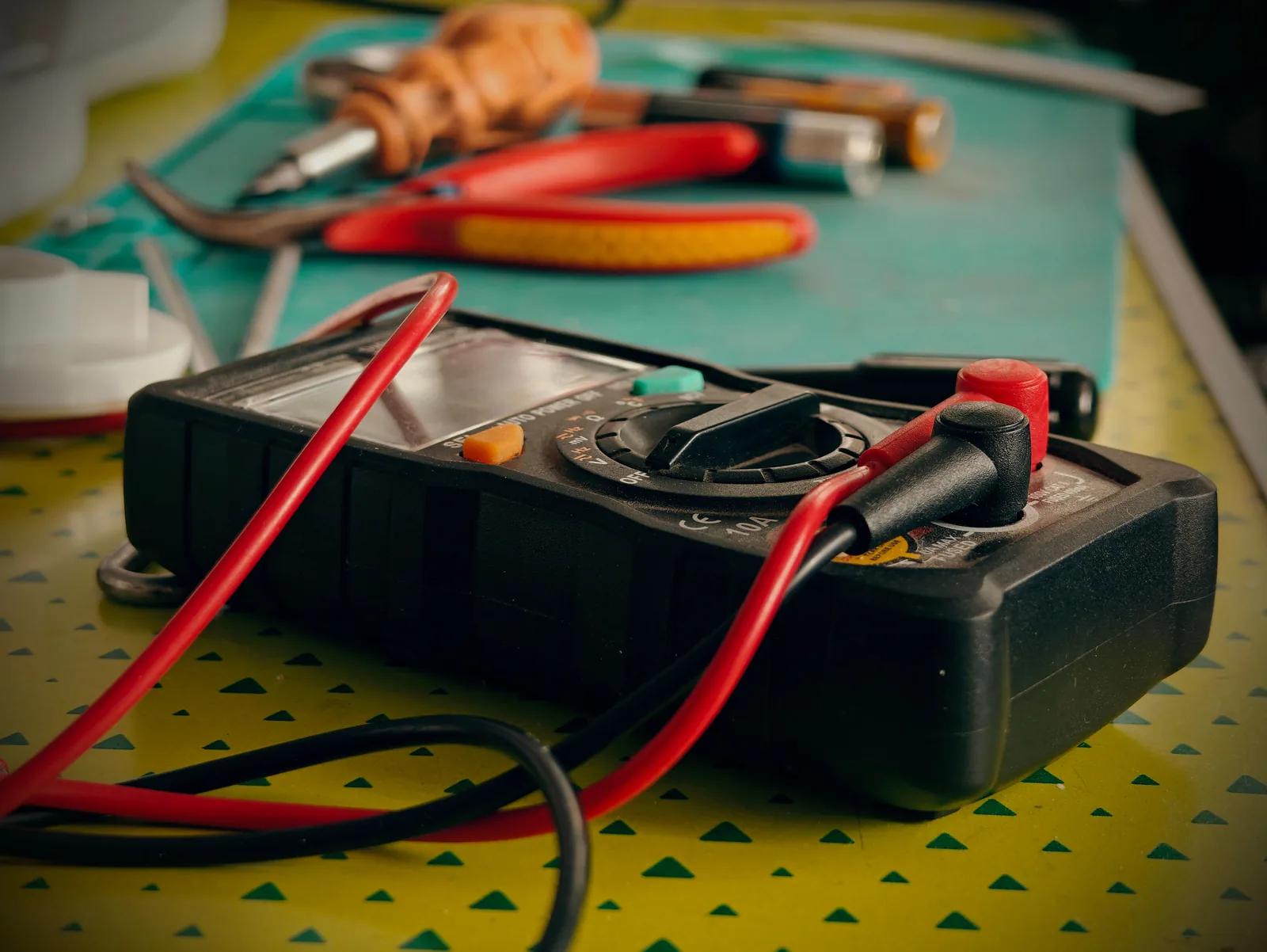 A multimeter and hand tools ready for a diagnostic visit, for electrician in London